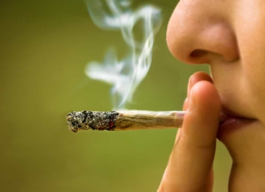 Individual Smoking Marijuana Cigarette